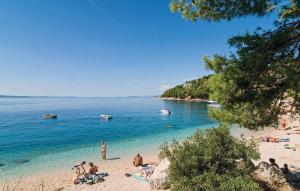 a group of people on a beach in the water at Mirabilis - Private Beach House in Lokva Rogoznica