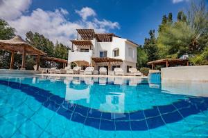 a villa with a swimming pool in front of a house at Yasmin Villa EL Gouna in Hurghada