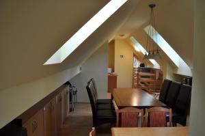 a kitchen and dining room with a table and chairs at Privat Podlesom in Kežmarok