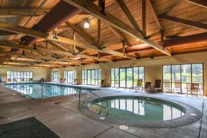 a large indoor swimming pool in a building with windows at Trees and Tees at Eagle Crest in Redmond