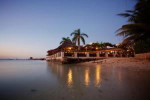 a restaurant on a beach with lights on the water at Hotel Slipway in Dar es Salaam