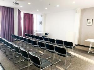 a row of chairs in a room with purple curtains at Reikartz Sky Almaty in Almaty +95 photos
