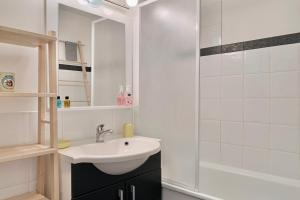 a white bathroom with a sink and a shower at The moon setting #AH5 in LʼHuez