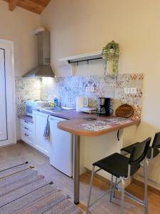 a kitchen with a table and two chairs at Fox Tale Guest House in Fternón