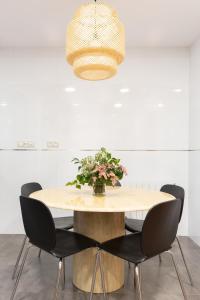 a dining room table with chairs and a light fixture at Unamuno by Bilbao Living in Bilbao