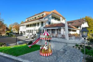 a large building with a circus tent in front of it at Gasthof zum Schlüssel in Ueberstorf