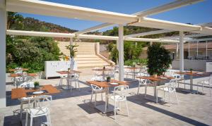 a group of tables and chairs under a pavilion at Chia Laguna - Hotel Village in Chia