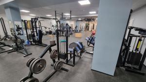 a gym with lots of machines and weights at Olympland Hotel in Trutnov