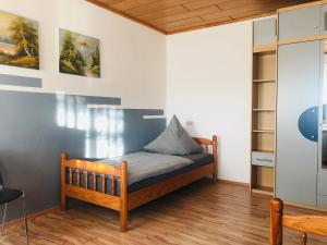 a bedroom with a wooden bed in a room at Stumpf Verpachtung Gbr in Treuchtlingen