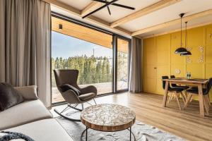 a living room with a table and chairs and a large window at Rezydencja Boutique SKI - 200m do Term Bania, Odkryj-Bialke in Białka Tatrzańska