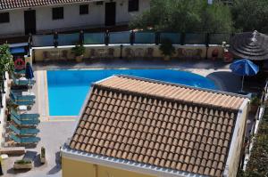 an overhead view of a swimming pool with a tile roof at Corfu Secret Hotel in Ipsos