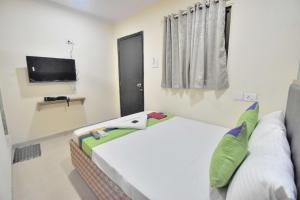 a small room with a bed and a television at BALAS RESIDENCY in Mumbai