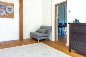 a living room with a chair and a dresser at Romantic stay, close to the beach and city centre! in Pärnu