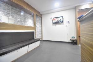 a waiting room with a bench and a door at BALAS RESIDENCY in Mumbai