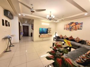 a living room with a couch and a tv at Executive 3 Bedrooms Apartment In Bahria Town in Rawalpindi