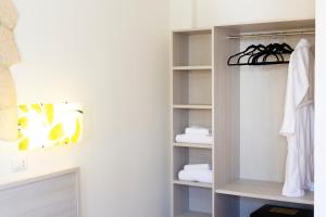 a walk in closet with white towels on shelves at Fattoria il Duchesco in Alberese +85 photos