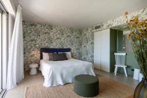 a bedroom with a bed with a blue headboard at Casa Lou in Olmeto