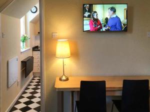 a room with a table and a tv on the wall at The Feversham in York