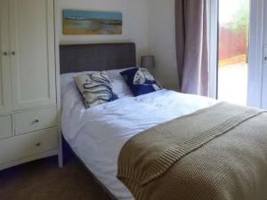 - une chambre avec un lit à côté d'une fenêtre dans l'établissement Wold Cottage, à Hunmanby