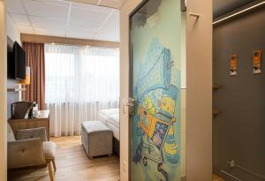 a room with a door leading to a room with a bedroom at Food Hotel in Neuwied
