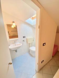 a bathroom with a sink and a toilet at Bilocale Via del Mare in Marina di Bibbona +11 photos