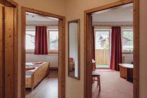 a bedroom with a bed and a mirror at Landhaus Cornelia in Berwang