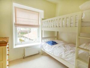 a bedroom with a bunk bed and a window at The Green in Lastingham