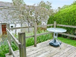 a table sitting on top of a wooden deck at Baytree Apartment in Grange Over Sands