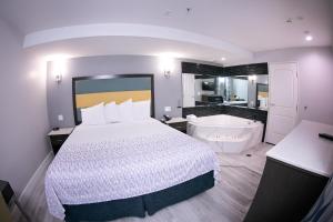 Habitación de hotel con cama y bañera en Travelodge Inn & Suites by Wyndham West Covina, en West Covina