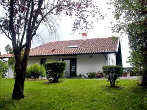 a white house with a red roof in a yard at Villa Landaboure by Interhome in Urcuit