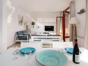 a dining room with a table with a bottle of wine at Apartment Cofisa-2 by Interhome in Jávea +32 photos