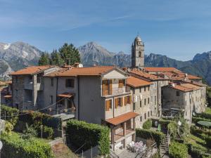 a group of buildings with a clock tower in the background at Holiday Home Da Franca by Interhome in Stazzema