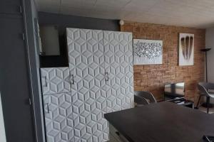 a kitchen with a refrigerator in a room at T2 1ère ligne loggia vue mer 180 ° parking in Arcachon
