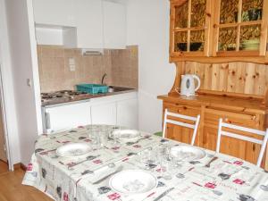 a kitchen with a table with plates on it at Apartment L'Enclave I et J-7 by Interhome in Les Contamines-Montjoie