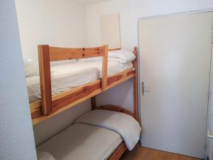 two bunk beds in a small room with a door at Apartment L'Enclave I et J-7 by Interhome in Les Contamines-Montjoie