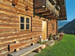 a log cabin with a bench in front of it at Chalet Sturmbachhütte - UTD110 by Interhome in Uttendorf