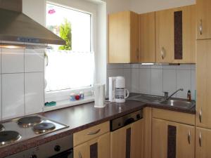 a kitchen with wooden cabinets and a sink and a window at Apartment Apartment Frisch by Interhome in Imst