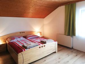 a bedroom with a bed with red blankets on it at Holiday Home Katharina by Interhome in Gröbming