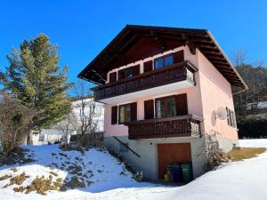 a house with a balcony in the snow at Holiday Home Lux by Interhome in Öblarn