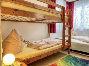 a bunk bed room with two bunk beds with a lamp at Holiday Home Landhaus Grüne Oase by Interhome in Sankt Martin am Grimming