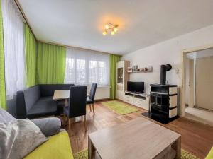 a living room with a couch and a table at Holiday Home Landhaus Grüne Oase by Interhome in Sankt Martin am Grimming +30 photos