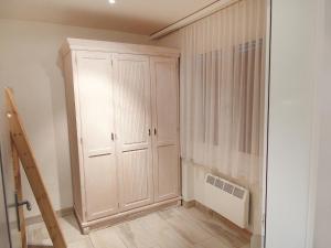 a room with a white cabinet and a radiator at Apartment Collina Verde B by Interhome in Ascona