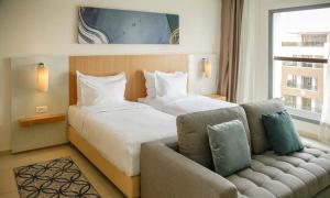 a hotel room with a large bed and a couch at Zephyr Agadir in Agadir