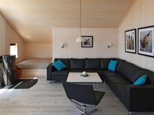 a living room with a couch and a table at Holiday Home Holiday Vital Resort - GBE111 by Interhome in Großenbrode