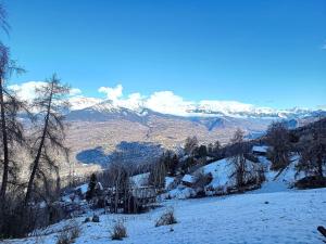 a snow covered mountain with mountains in the background at Apartment Bellevue L by Interhome in Veysonnaz
