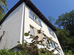 a white building with windows on the side of it at Holiday Home Christa by Interhome in Bissone