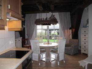 a kitchen with a table and chairs and a window at Holiday Home Sielmühle by Interhome in Middelsbur