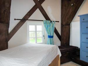 a bedroom with a bed and a window at Holiday Home Sielmühle by Interhome in Middelsbur