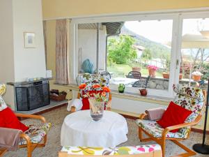un soggiorno con tavolo, sedie e finestra di Holiday Home Cityview Lugano - Casa Carlo by Interhome a Cadro