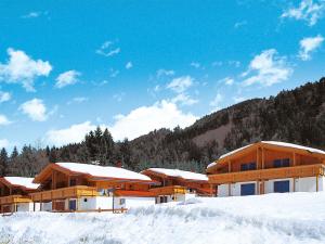 a building with snow on the ground in front of it at Holiday Home Chalet Walchsee by Interhome in Sachrang